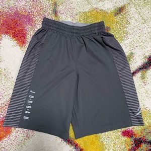 These are grey Jordan Dri-FIT basketball shorts with white striped side panels.